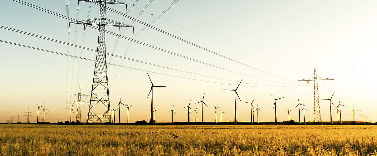 Strommasten und Windkraftanlagen © kflGALORE / iStock / Getty Images