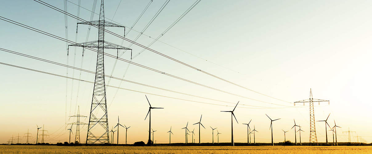Strommasten und Windkraftanlagen © kflGALORE / iStock / Getty Images