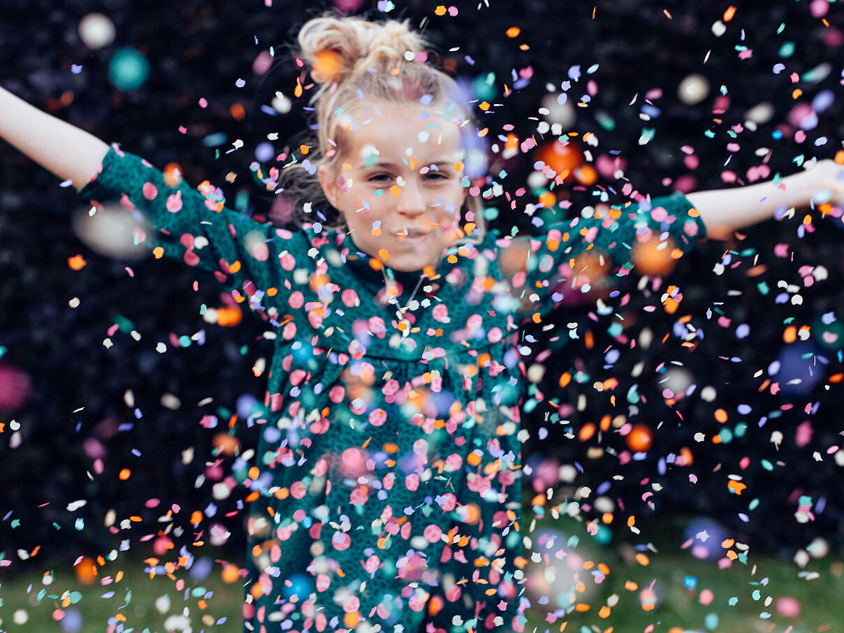 Mädchen wirft Konfetti 