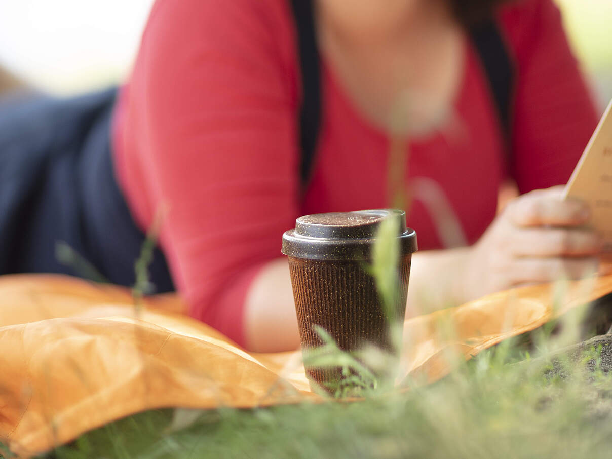 Kaffee im Park in einem Mehrweg-Trinkbecher