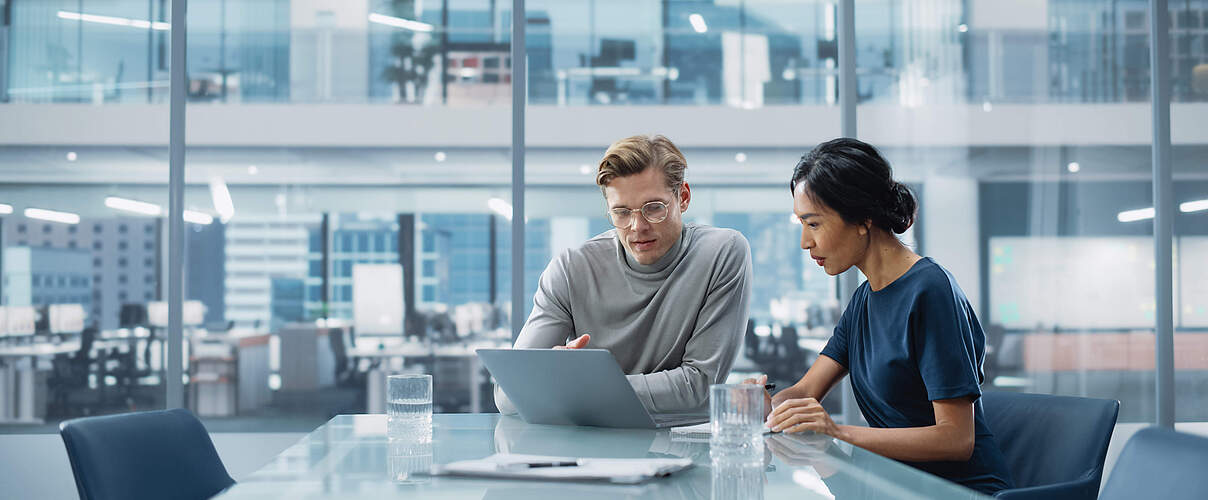Multiethnic Diverse Office Conference Room Meeting: Team of Two Creative Entrepreneurs Talk, Discuss Growth Strategy. Stylish Young Businesspeople work on Investment and Marketing Projects.
