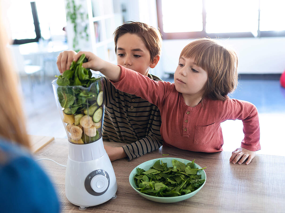 Kinder mixen einen Smoothie