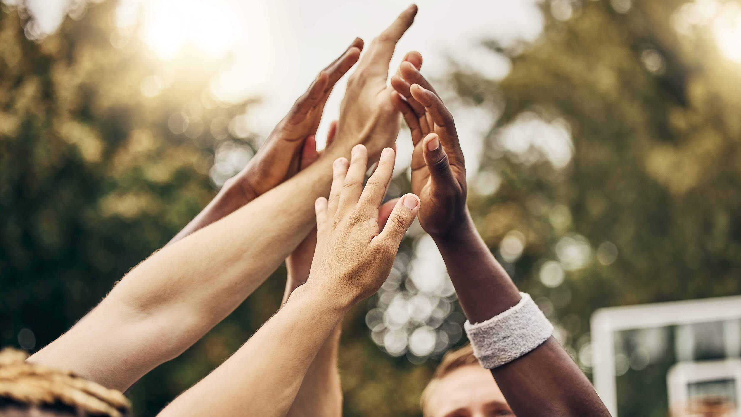 Basketball, winner and hands, team high five for outdoor game. Success, diversity and victory goal for sports for men. Teamwork, diversity and support, friends on basketball court together with coach