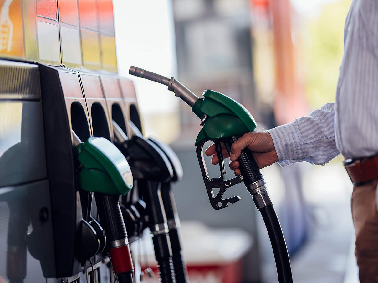 Close-Up of Man Refueling Vehicle at Gas Station Pump
