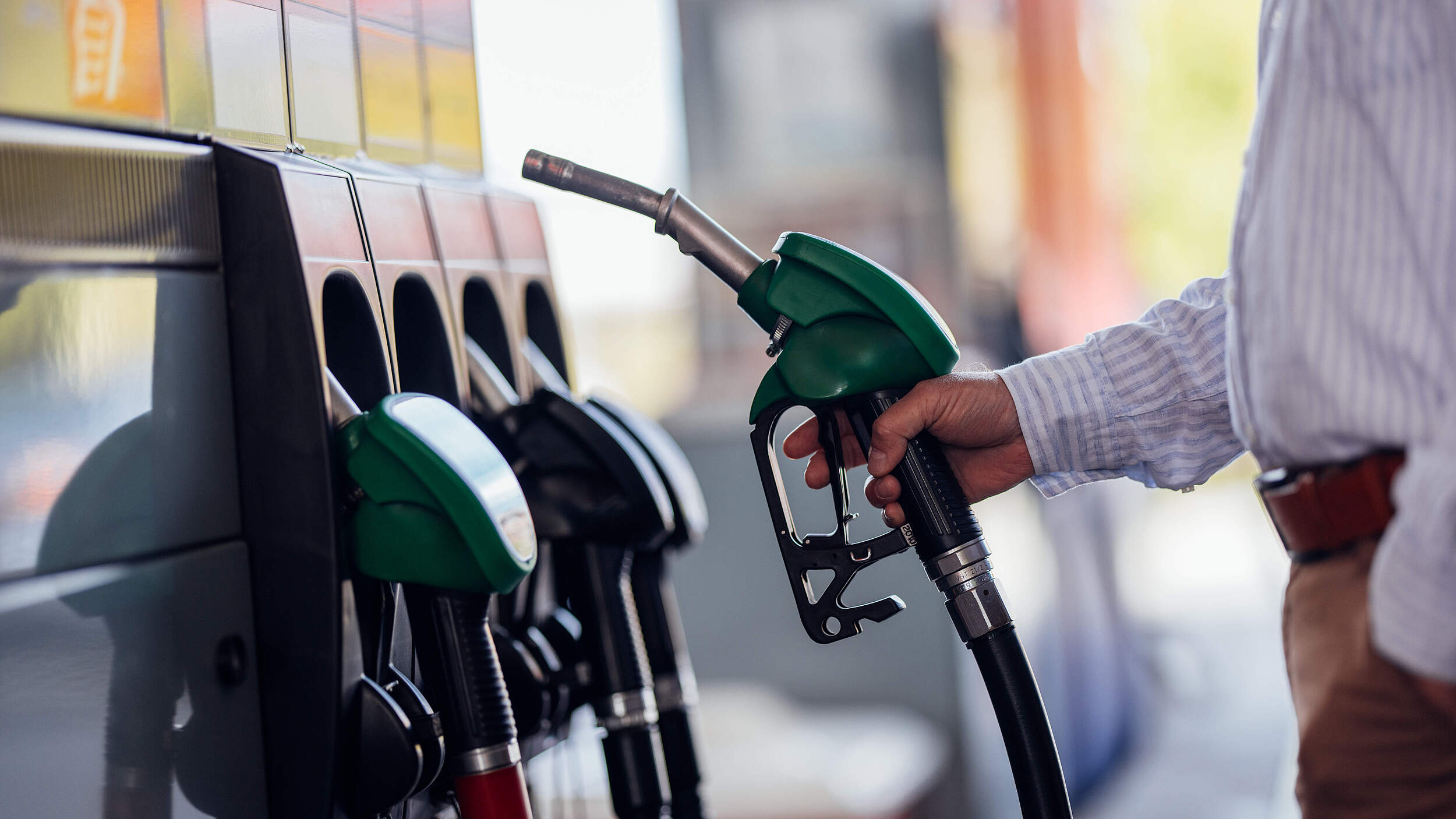 Close-Up of Man Refueling Vehicle at Gas Station Pump