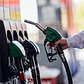 Close-Up of Man Refueling Vehicle at Gas Station Pump