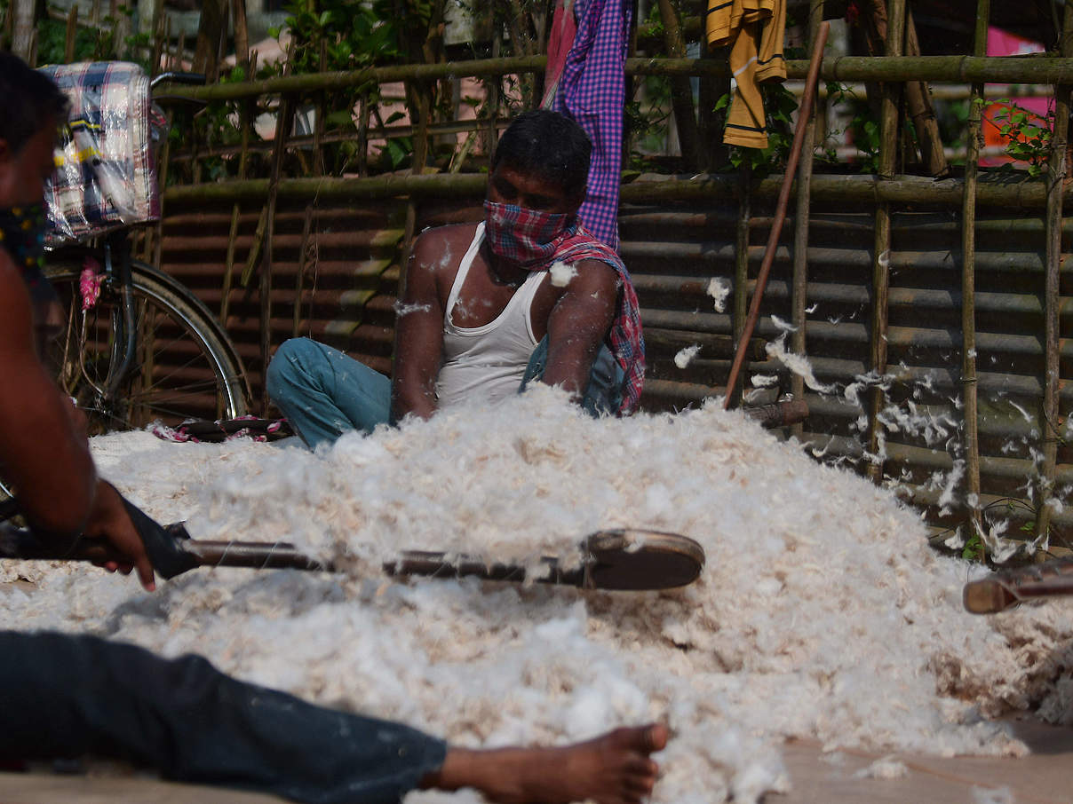 Artisans working at a cotton factory during the beating process in the outskirts of Agartala. Traditional beating cotton